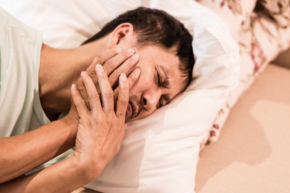 TMD and TMJ healthcare concept: Temporomandibular Joint and Muscle Disorder. Asia man hand on cheek face as suffering from facial pain, mumps or toothache