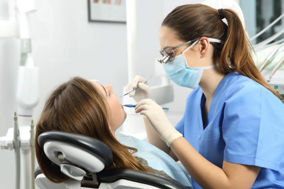 Dentist performing dental sealants treatment on patient in North York