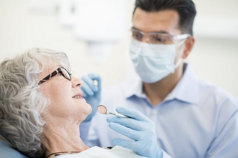 Old patient going through oral cancer screening in North York