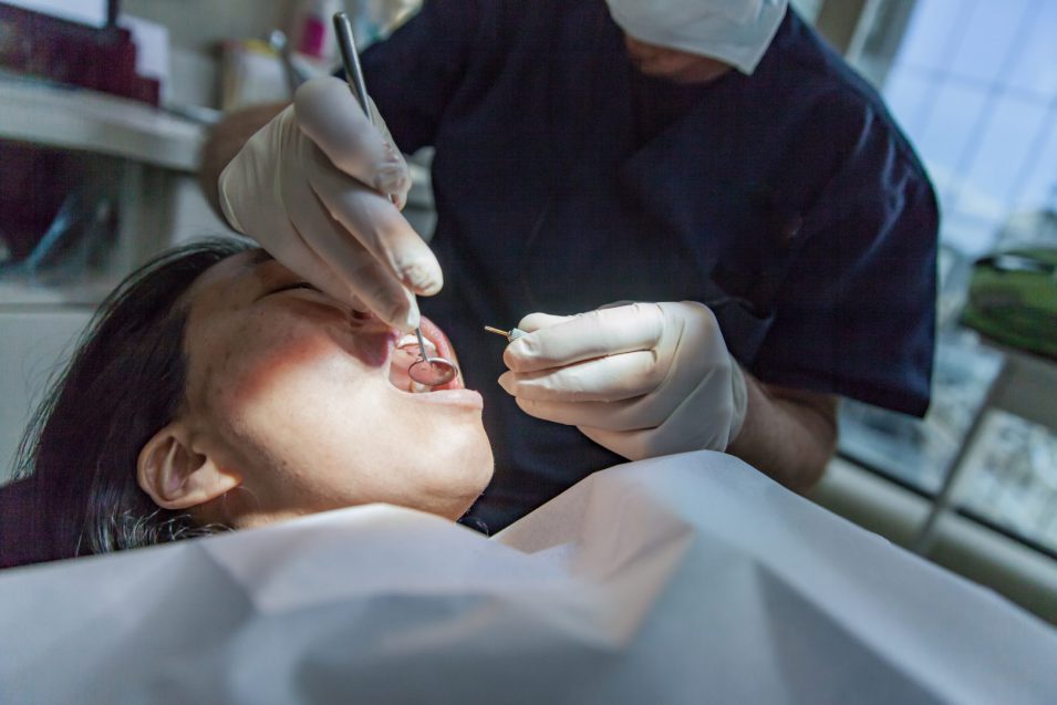 Dentist performing oral and maxillofacial surgery in north york