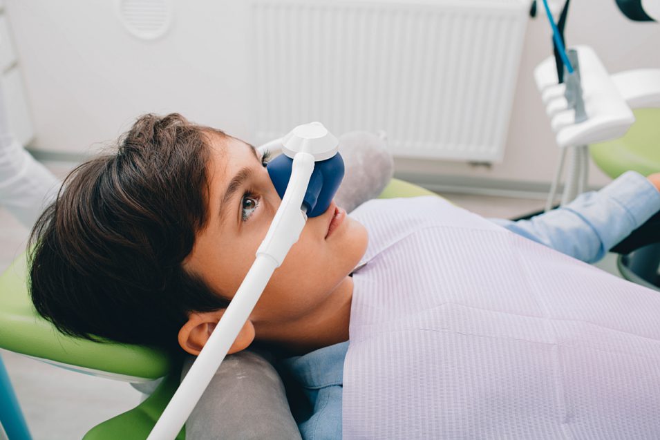 Little patient getting sedation dentistry in dental clinic nearby