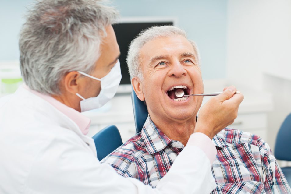 Periodontist in North York examining patient in dental office